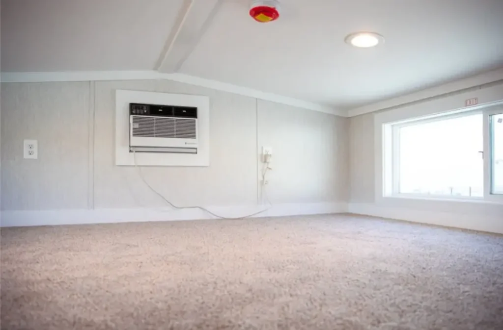 Spacious carpeted upper loft area inside a park model cabin, ideal for extra guest sleeping mats.